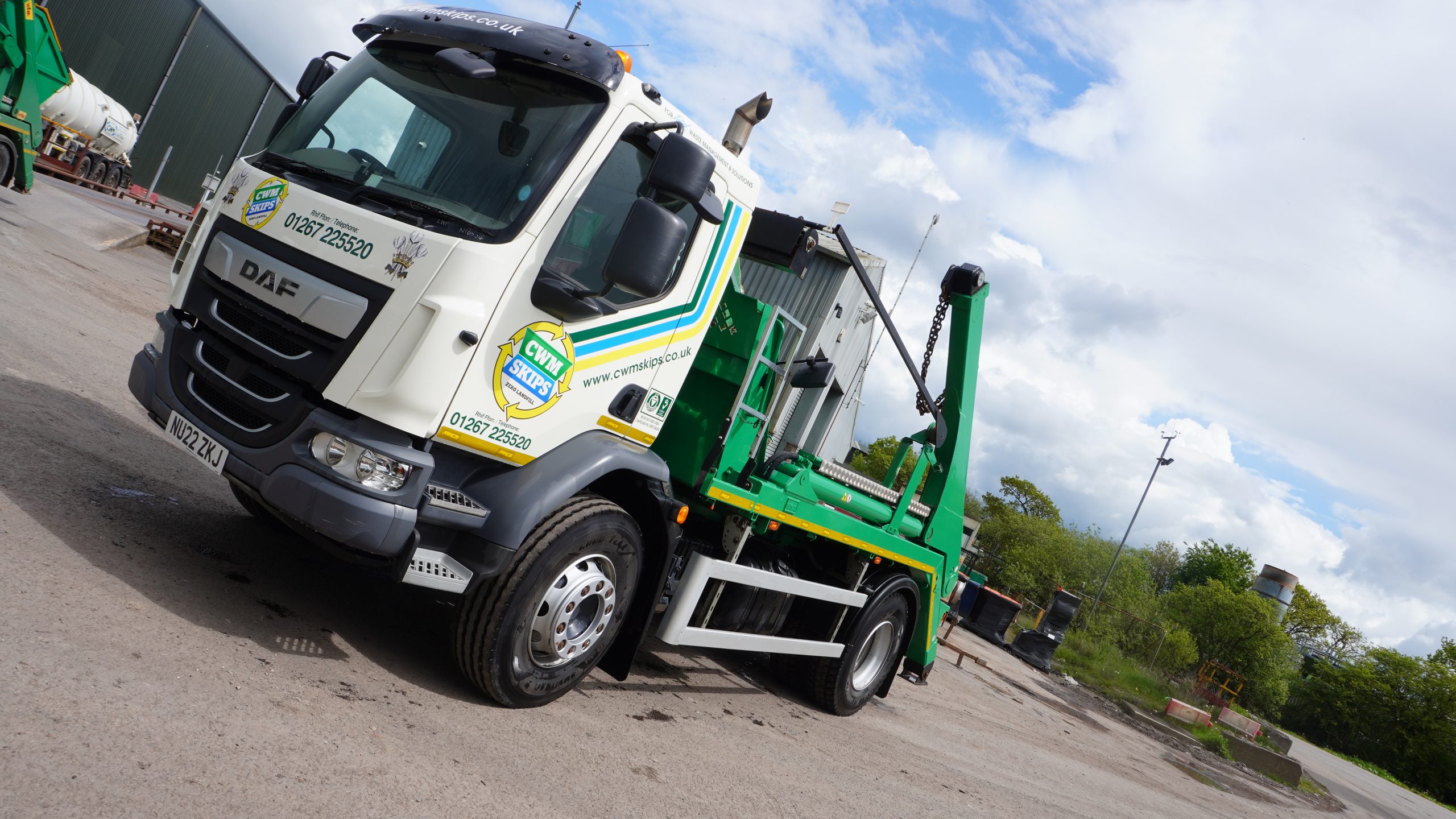 A skip lorry with CWM Skips written on the side of the cab