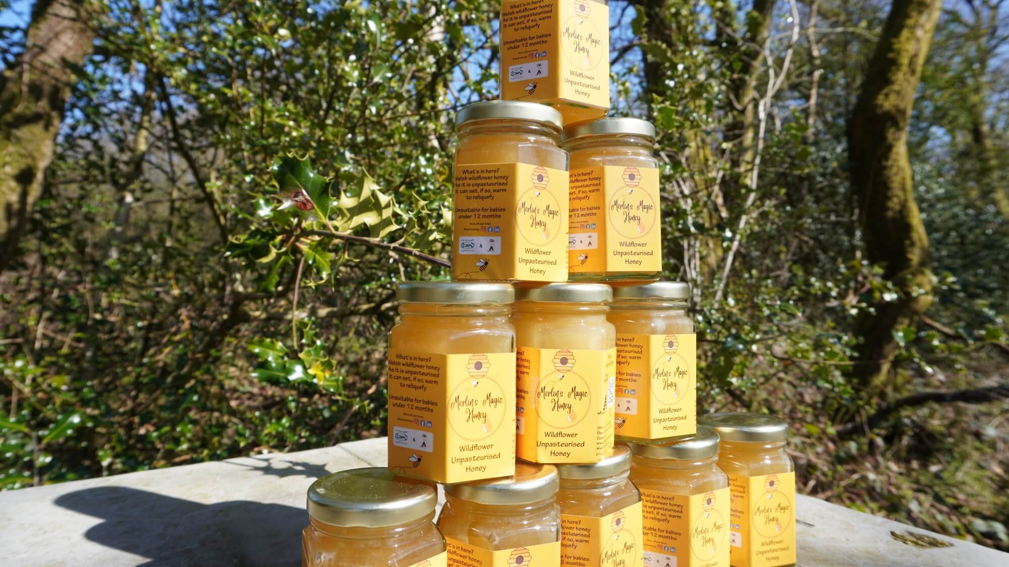 A stack of Merlin's Magic Honey jars